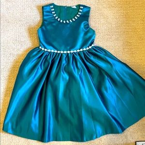 teal dress with bow and headed detail